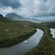 A tour boat cruising through a verdant waterway